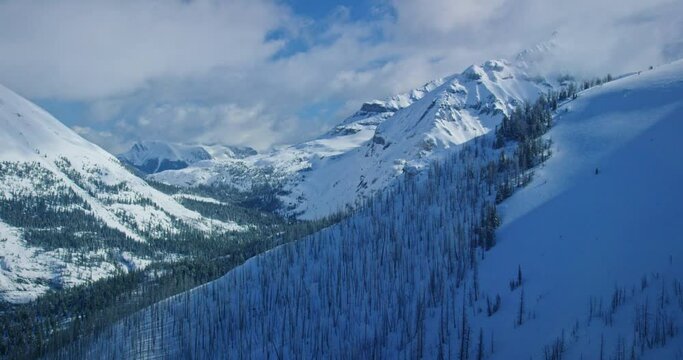 Helicopter aerial, snowy mountain range in Banff National Park