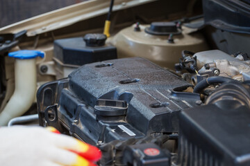 Repair. Car repair services. The hood of the car, to check the status of damage. A car mechanic works in the garage.