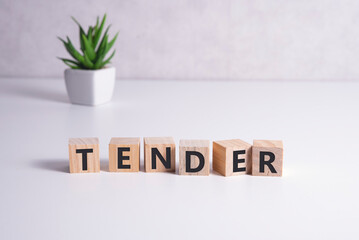 Letter block in word tender on wood background