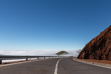 Winding mountain road above the clouds on the island of Tenerife