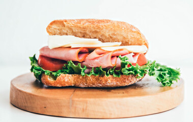 Ham, cheese, tomato and lettuce sandwich.