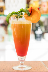 Drink with alcohol and fruits. Sweet cocktail. Strawberries, mint and orange.