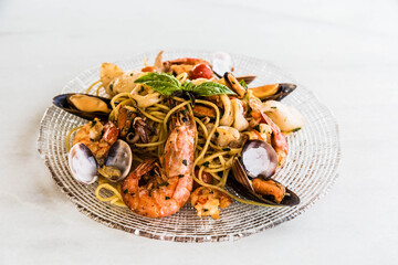 Dish with Peruvian-Chinese fusion food with prawns, shells, noodles and vegetables.