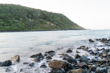Fototapeta na wymiar Burleigh headland slow exposure with rocks in the foreground