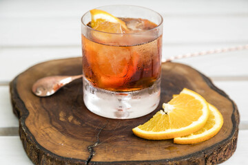 Drink with alcohol. Vermouth with lemon on a wooden board