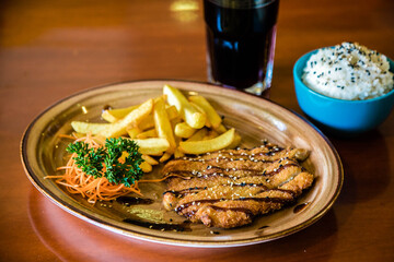 Milanese with carrots and French fries. Asian food.