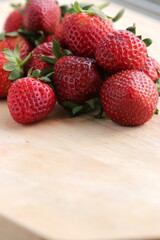 Strawberries on wooden chopping board