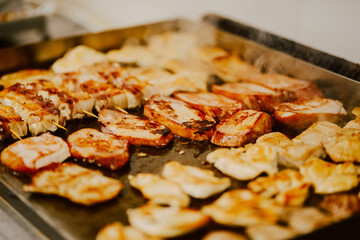 Delicious meat is baked in the kitchen of the restaurant. Preparing meat for guests