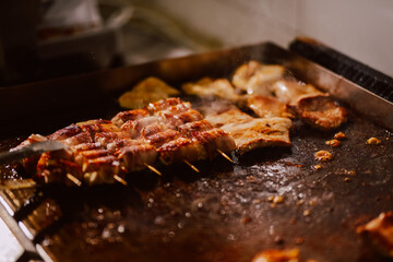 Delicious meat is baked in the kitchen of the restaurant. Preparing meat for guests