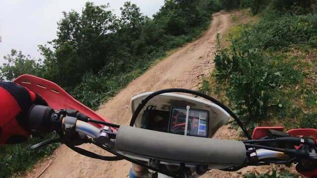 Pov of Professional Motocross Motorcycle Rider Drives Over the Road Track