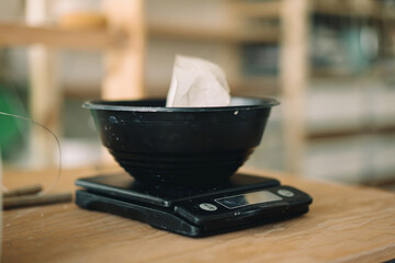 Weighting scales with the clay dough