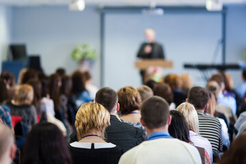 Conferences Concept. Male Lecturer Speaking In Front of the Audience During The Conference.