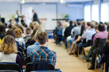 Two Male Hosts on Stage in Front of  The Audience During Conference.