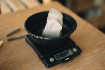 Weighting scales with the clay dough