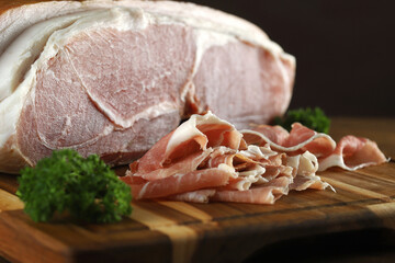 Parma ham in sliced close-up on wooden board