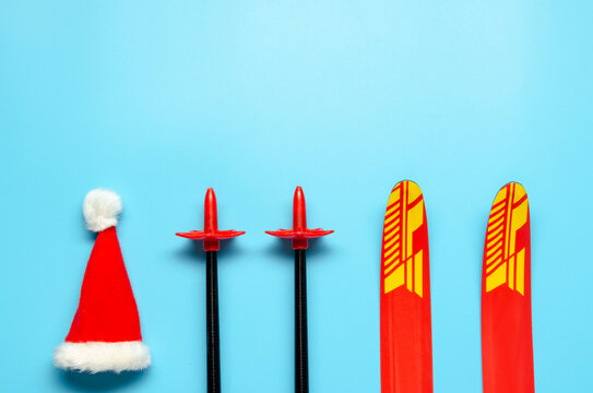 Winter sports layout with pair of skis and christmas hat. Christmas or New Year concept. Flat lay.