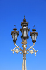 Fototapeta na wymiar Traditional decorative lamp post against blue sky background 