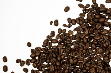 Roasted coffee beans against a white background.