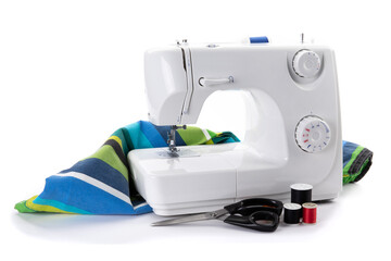 a white electric sewing machine and scissors and thread isolated on white