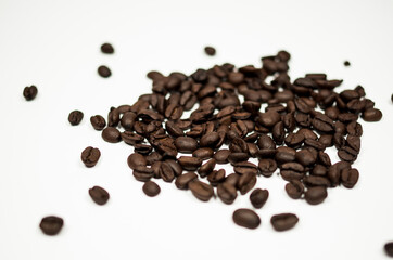 Roasted coffee beans against a white background.