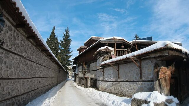 Street view, traditional houses and high snow in bulgarian ski resort