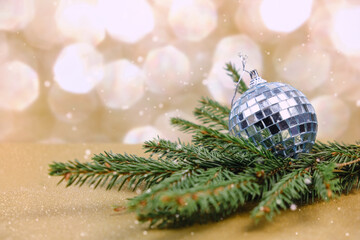Silver Christmas ball with twig of Christmas tree. Christmas decoration concept.
