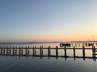 Sunrise over the bay, pier reflecting light