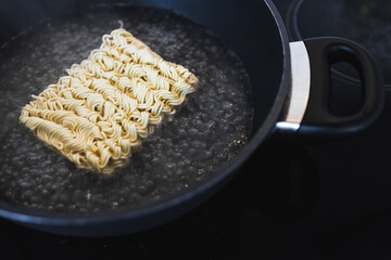 simple food ingredients, noodles cooking in pan on kitchen stove top