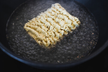 simple food ingredients, noodles cooking in pan on kitchen stove top