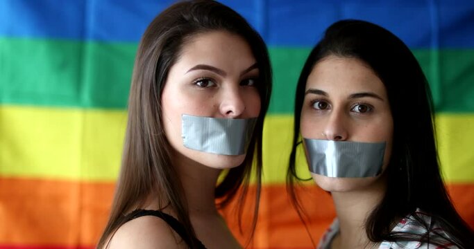 Portraits of two lesbian girlfriends unable to speak censored with duct tape in mouth, LGBT freedom of speech