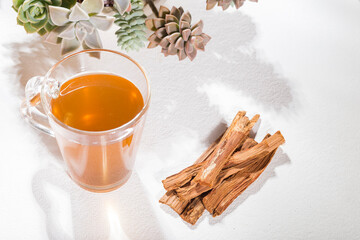 Bark and tea of cat's claw plant on white background