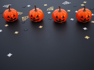 Top view of pumpkin, spiders and web shape on black grunge texture for halloween background
