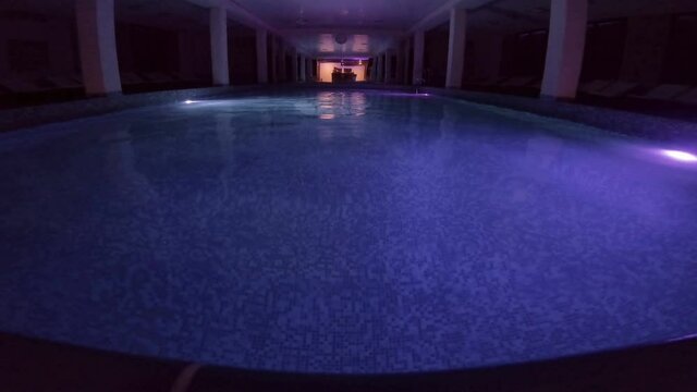 Scene of luxury swimming pool for swimming and recreation at night