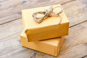 diy gift concept - Homemade wrapped christmas presents decorations on wooden , DIY hobby gift box wrapped brown paper collection in for christmas or new year