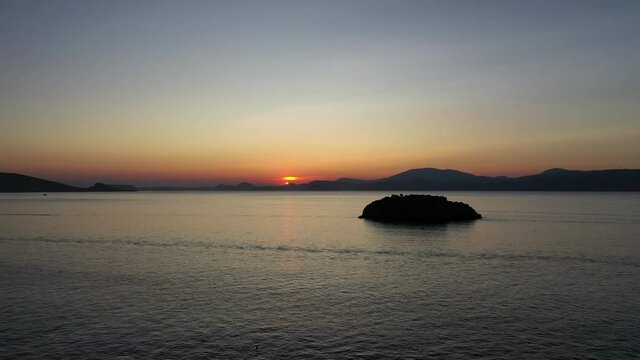 A small island in front of Vlychos Plakes Beach in Hydra Island, Greece
