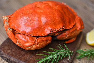 Seafood shellfish Steamed red crab or Boiled stone crab - Fresh crab with ingredients lemon rosemary on wooden board