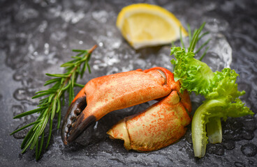 Seafood frozen boiled crab claws - Fresh crab with ingredients lemon rosemary on ice at market