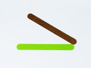 Manicure tools. Nail files isolated on a white background. The view from the top. Green nail file. Purple nail file.