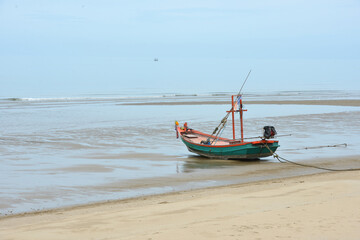 fishing boat on the beach with see and blue sky background in Thailand