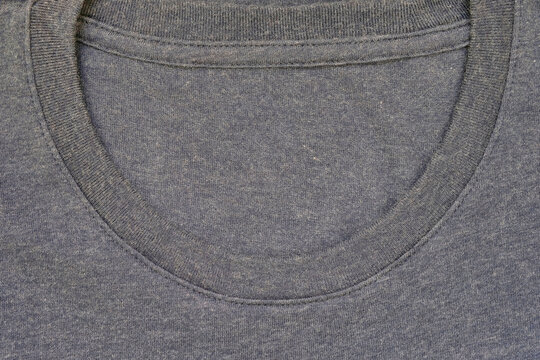 Round neckline without collar of a plain cotton T-shirt for casual wear. A crew neck tee shirt, closeup view. U neck, soft textile, no pattern clothing apparel for everyday wear.
