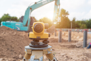 Surveyor equipment tacheometer or theodolite measurement for checking level excavation depth of foundation at construction site.