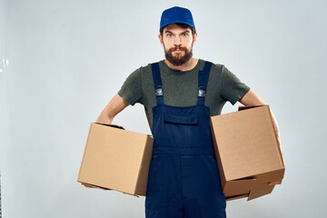 Male worker loading delivery boxes in hands packing lifestyle