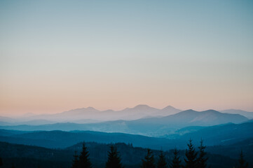 Fototapeta premium Silhouette of mountains, blue foggy mountains with mist and fog.