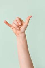 Hand showing letter Y on color background. Sign language alphabet