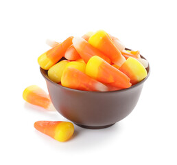 Bowl with tasty candies for Halloween on white background