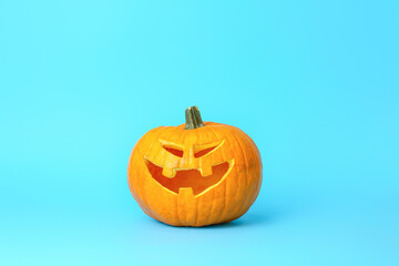Carved Halloween pumpkin on color background