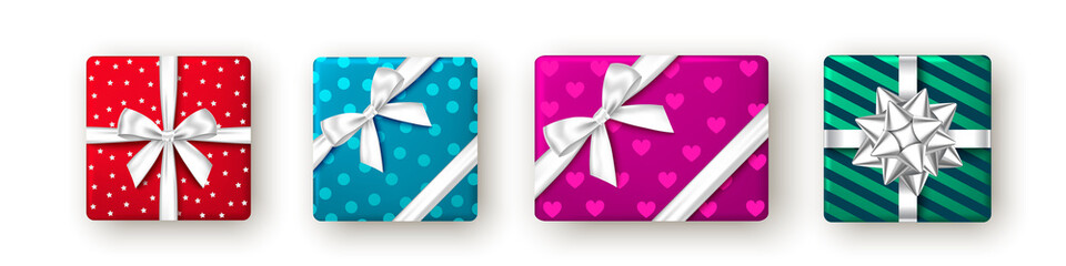 Red, blue, pink, green gift box with ribbon and bow.