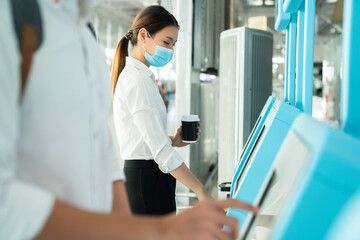 asian female business trip white cllar shirt self passport check in with automatic machine airport terminal safety travel concept new normal lifestyle