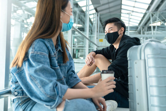 Safety Travel New Normal Lifestyle Asian Friend Couple Relax Sit Wait For Time Schedule To Aboard Departure,asian Male And Female Wearing Protective Face Mask In Airport Terminal