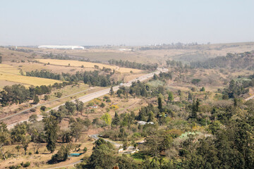Fototapeta na wymiar Asphalt Highway Running Through Green Vegetation in South Africa